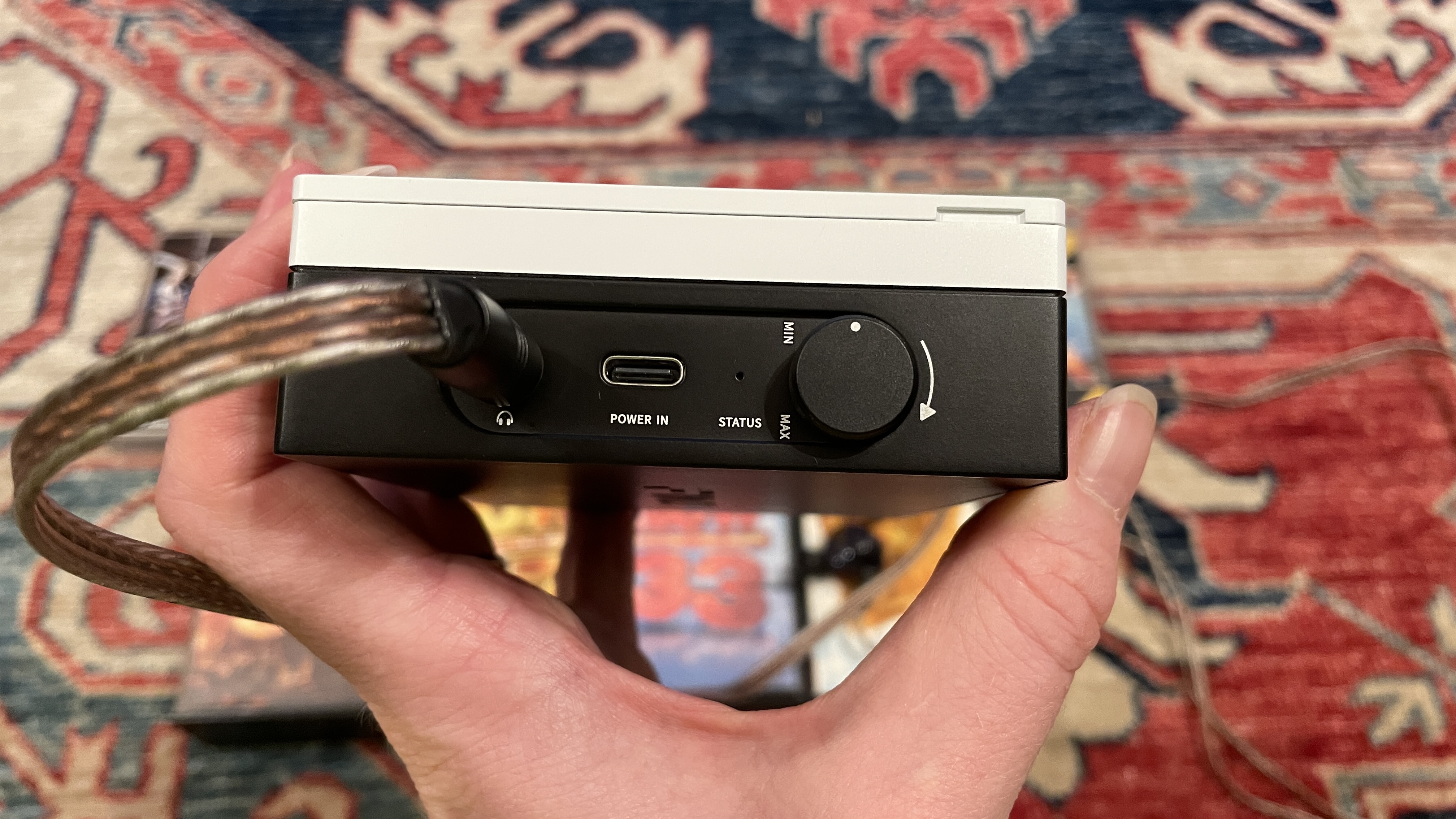 FiiO's CP13 with Campfire Audio Clara IEMs, on top of several cassette tapes, all on a colorful carpet