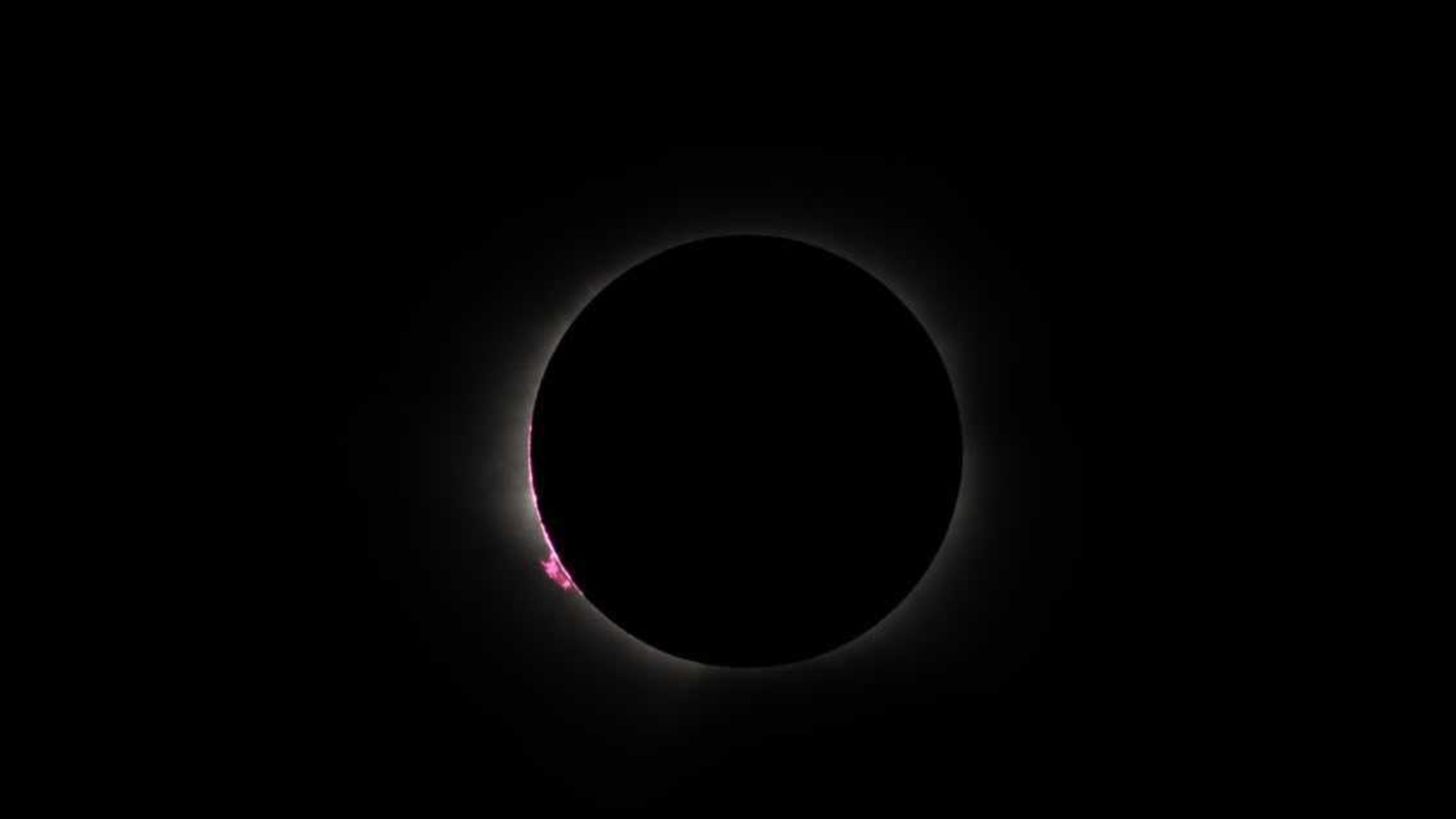 a thin white line of wispy light on a black background