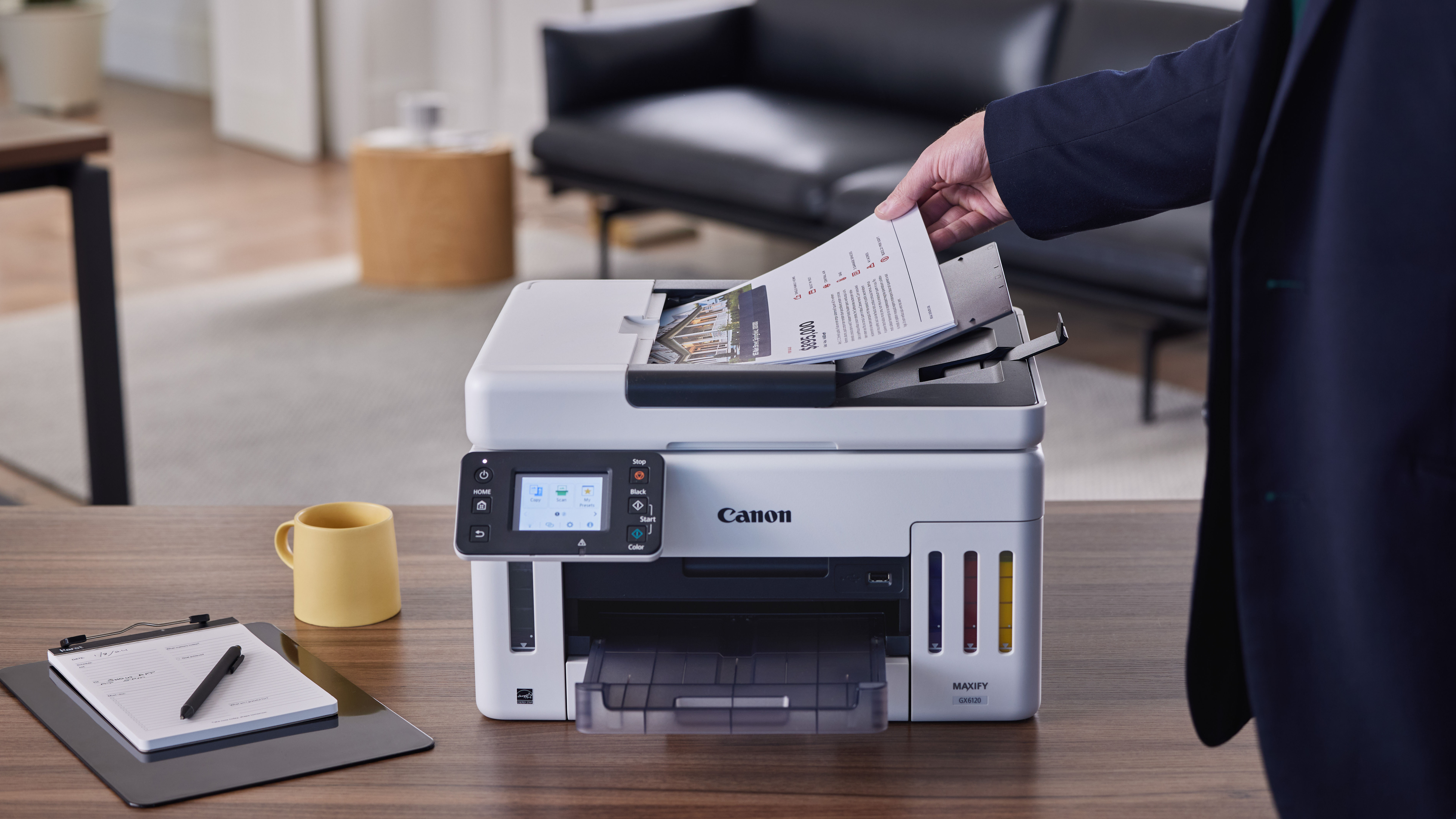 Canon MegaTank Printer in use by a business person.