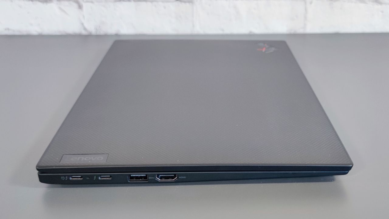A side-on photograph of the Lenovo ThinkPad X1 Carbon Gen 10 on a table