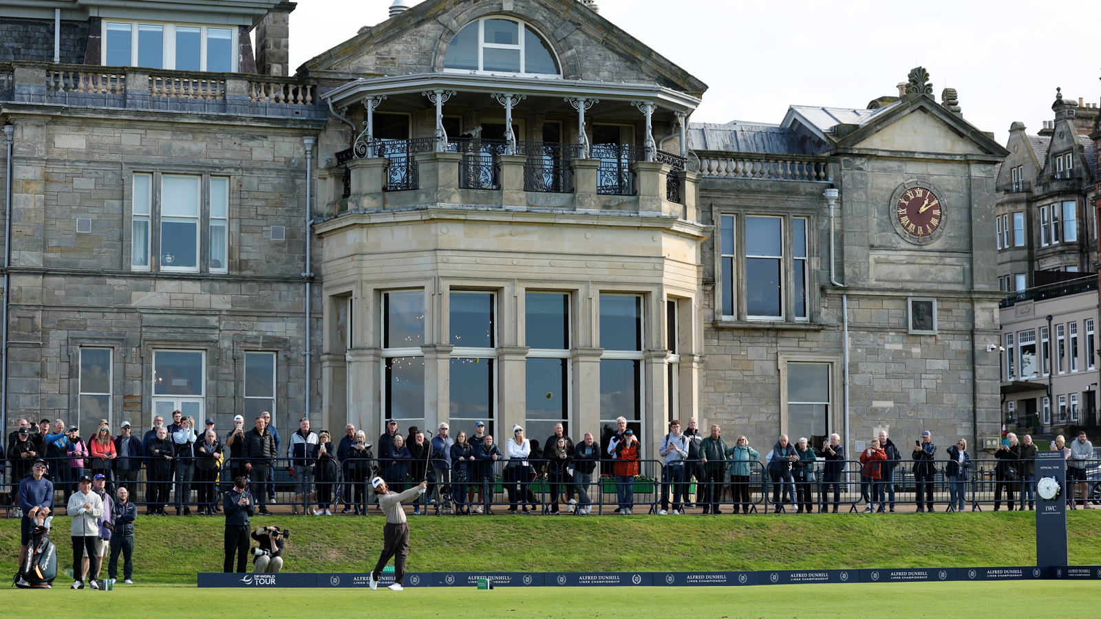 Tommy Fleetwood hits a shot in front of St Andrews' clubhouse