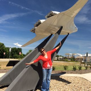 NASA newsletter editor Doreen Zudell poses for a #SpreadYourWings photo to celebrate National Aviation Day 2015 at NASA's Glenn Research Center in Ohio.