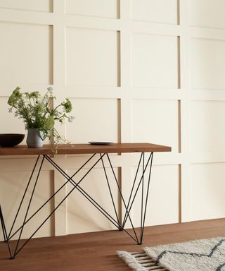 neutral panelled wall with console table