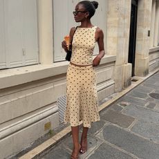 liv wears a white skirt set with polka dots