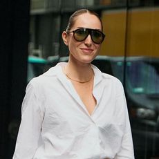 A woman wearing a white button down