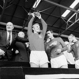 Bobby Moore lifts the Jules Rimet trophy at Wembley in 1966 (PA).