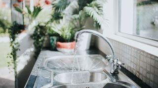 How to save water at home: Image shows running tap