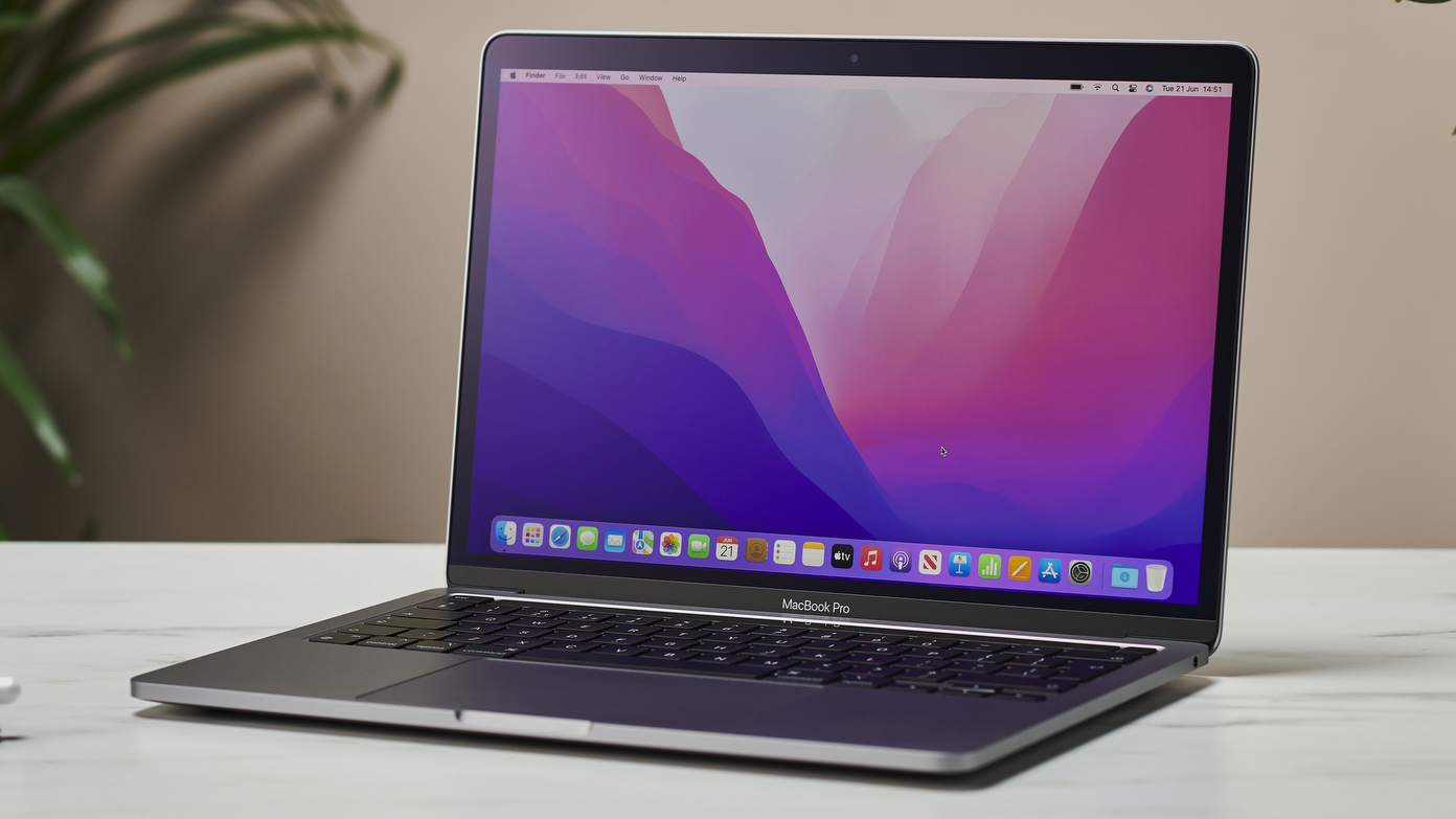 An Apple MacBook Pro laptop sitting on a white table