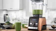 One of the best blenders on the market, the Vitamix A3500 blender on a countertop with green juice in front
