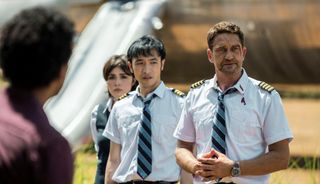 (From L to R) Daniella Pineda as stewardess Bonnie Lane, Yoson An as pilot Dele, and Gerard Butler as pilot Brodie Torrance in Plane (2023)