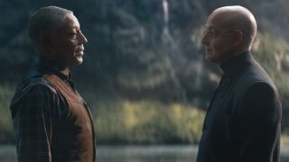 Giancarlo Esposito and Stanley Tucci have a conversation by a virtual lake in The Electric State.