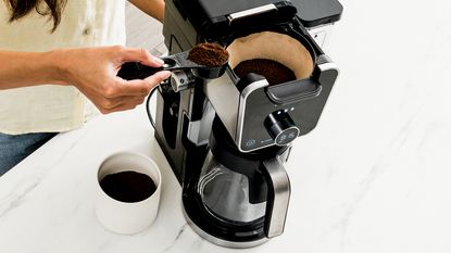 Coffee machine on a white marble countertop