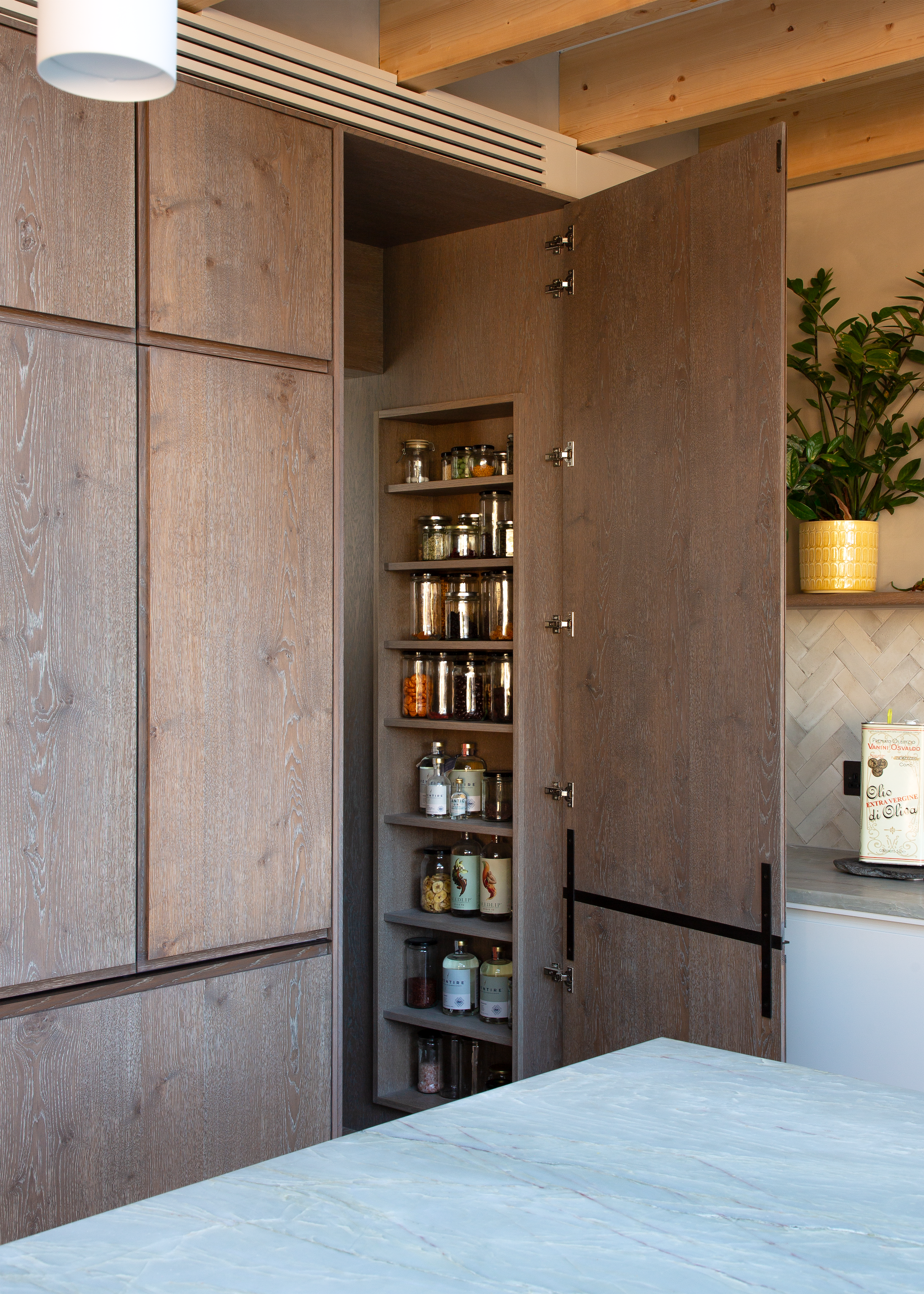 A corner of a kitchen showing how a corner can be transformed into a walk-in pantry instead of using standard corner cabinets