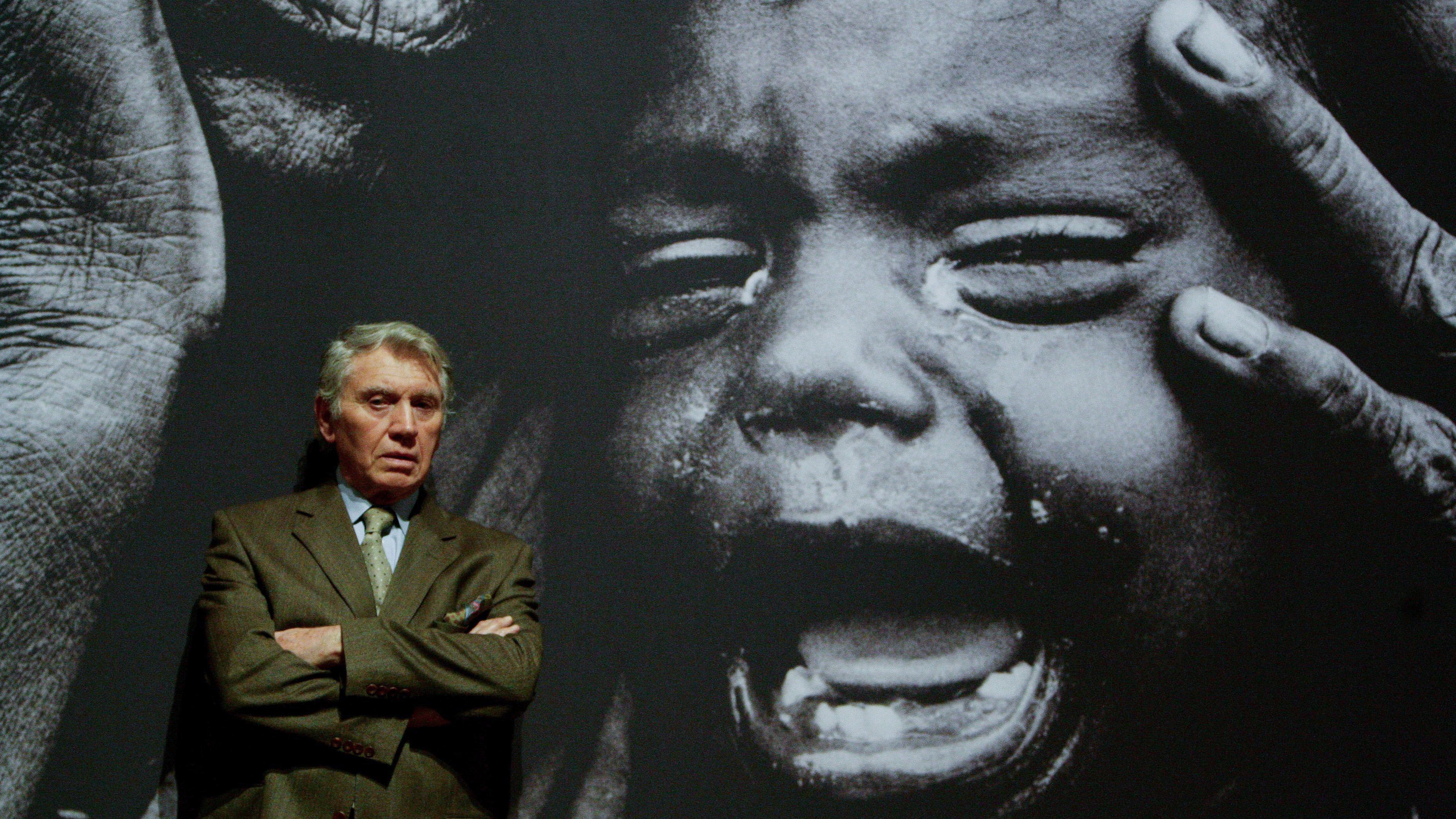 GCAB0H Photographer Don McCullin stands in front of one of his photographs on display in the Shaped by War exhibition at the Imperial War Museum North in Manchester.
