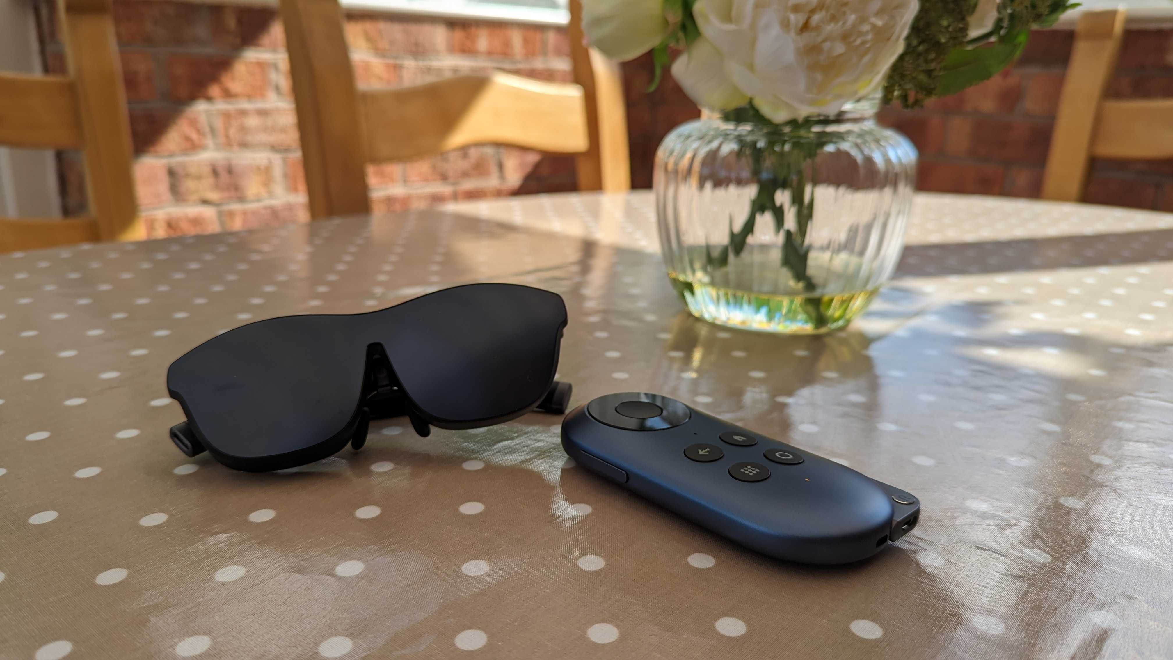 The Rokid Max AR glasses with a cover and the Rokid Station sat on a polka dot covered table