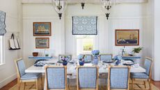 Dining room with white walls and blue gingham chairs and white table 