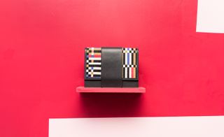 Patterned clutch bag with a red background