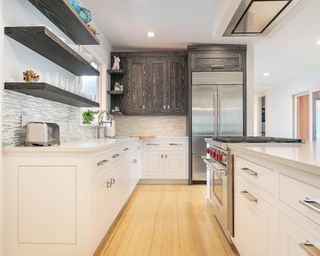 Small kitchen featuring neutral colour scheme and wooden flooring