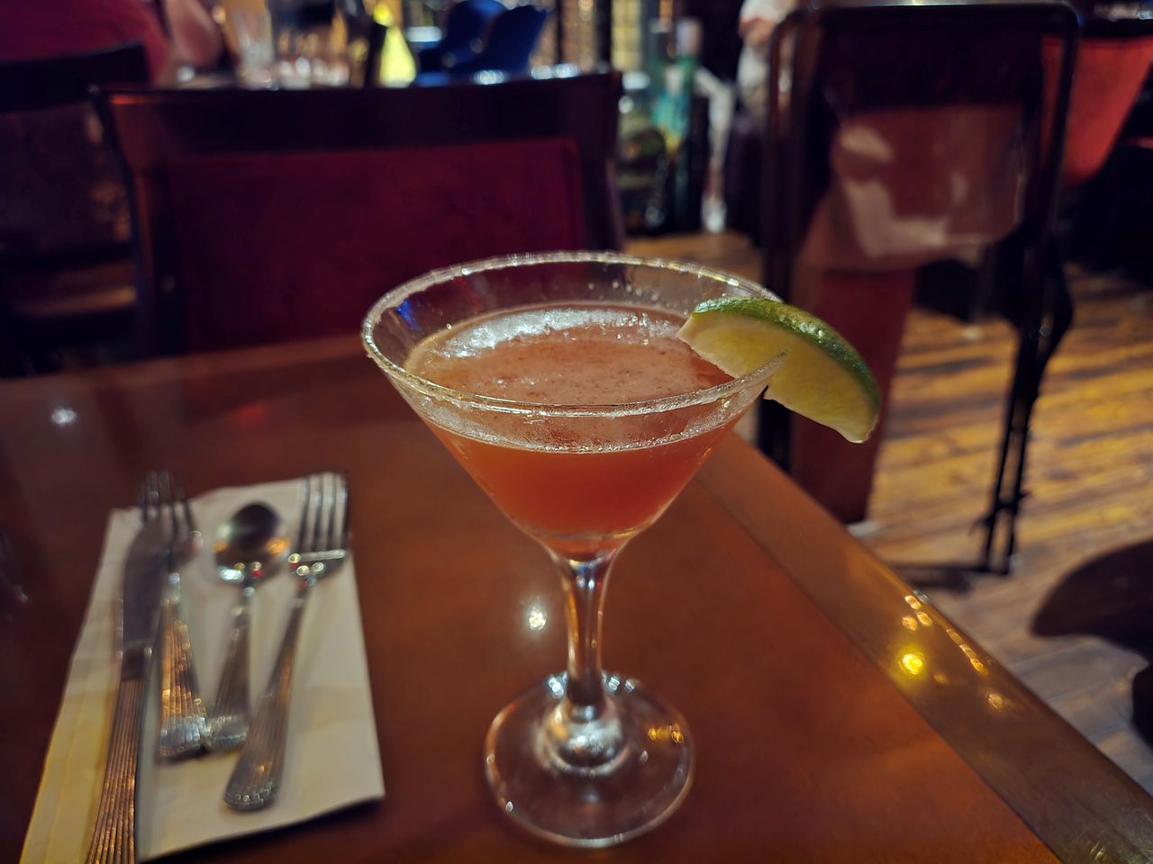 A martini glass with a beverage