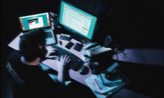 An overhead view of a person using a computer and laptop