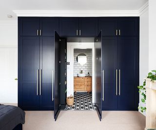 blue painted walk-in wardrobe leading to en suite bathoom