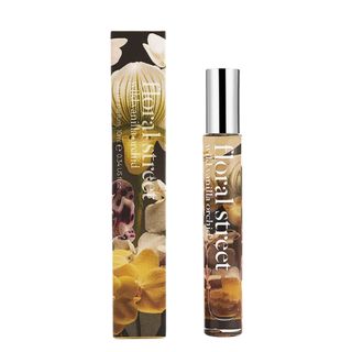 A press shot of the travel-sized Floral Street Wild Vanilla Orchid Eau de Parfum alongide its box