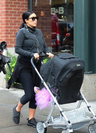 Kim Kardashian walks Baby North West to Soho Gym on September 10, 2015 in New York City