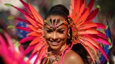 Notting Hill Carnival attendee in bright feathered costume