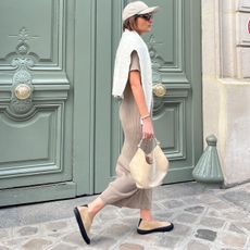 Woman wearing a baseball cap on a street in Paris