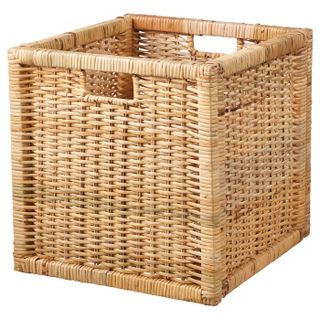 A cube shaped Rattan basket with cut out handles 