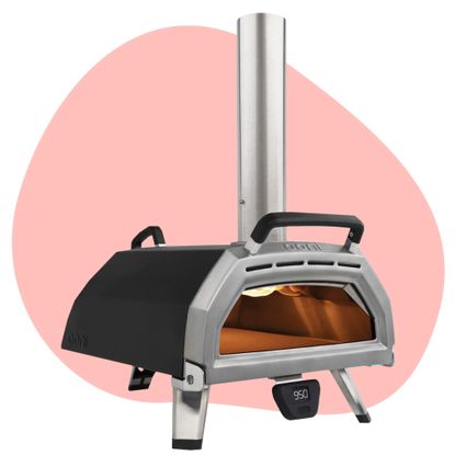 The Best pizza oven as tried by the Ideal Home team is an Ooni pizza oven, here on a pink background
