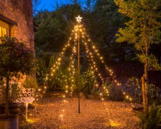 Outdoor DIY Christmas tree tower made with outdoor fairy lights