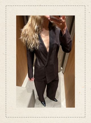 Eliza Huber in the dressing room at Massimo Dutti's new Miami store wearing a dark brown suit.