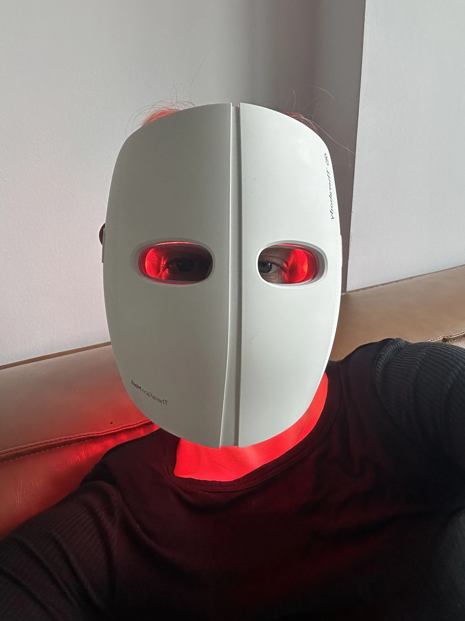Photo of Jamie Schneider wearing a red light mask