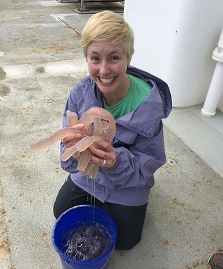 Jessie Masterman, who will be a doctoral student at the Oregon Institute of Marine Biology this fall, shows a double handful of sea pickles.