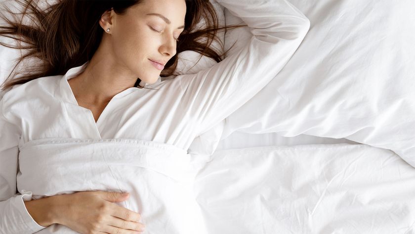 A woman lies on a bed relaxing