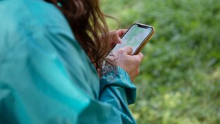 A woman looking at maps on her mobile phone