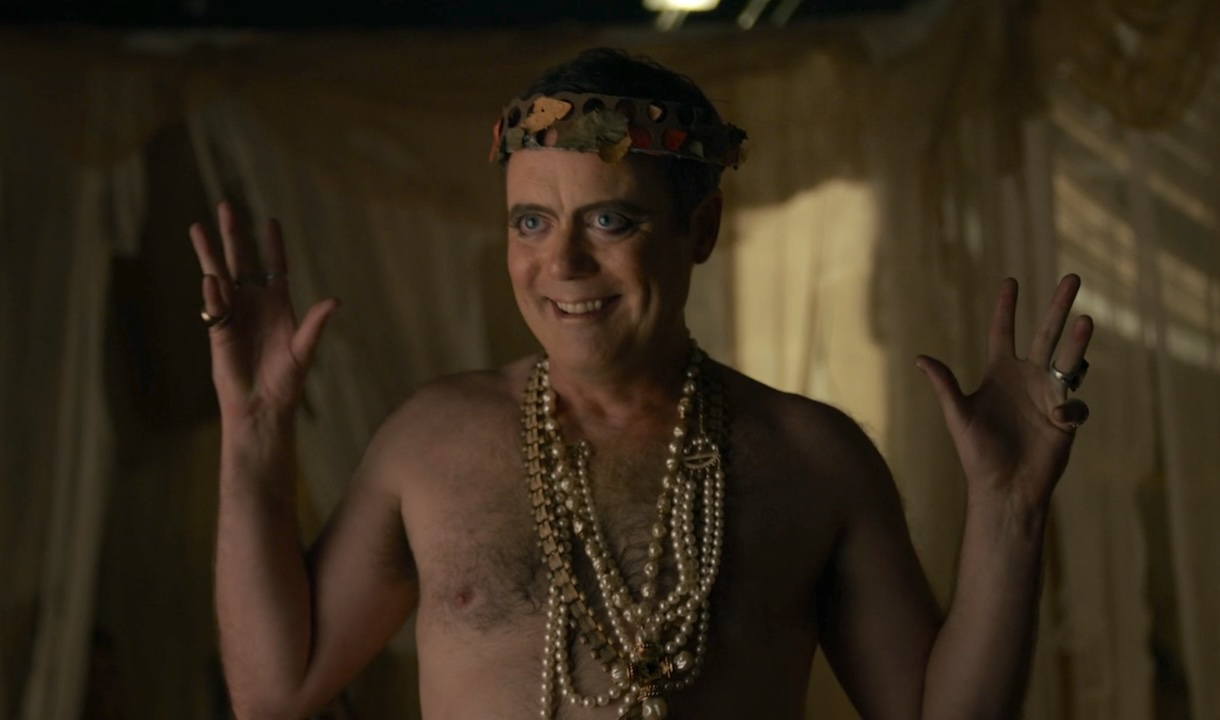 Jon Daly's Emperor shirtless with necklaces in Twisted Metal Season 2 