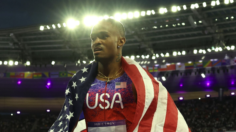 remote camera) Quincy Hall of Team United States wrapped in Old Glory ahead of the 