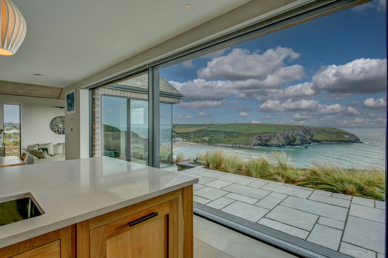A floor to ceiling window with views of the ocean