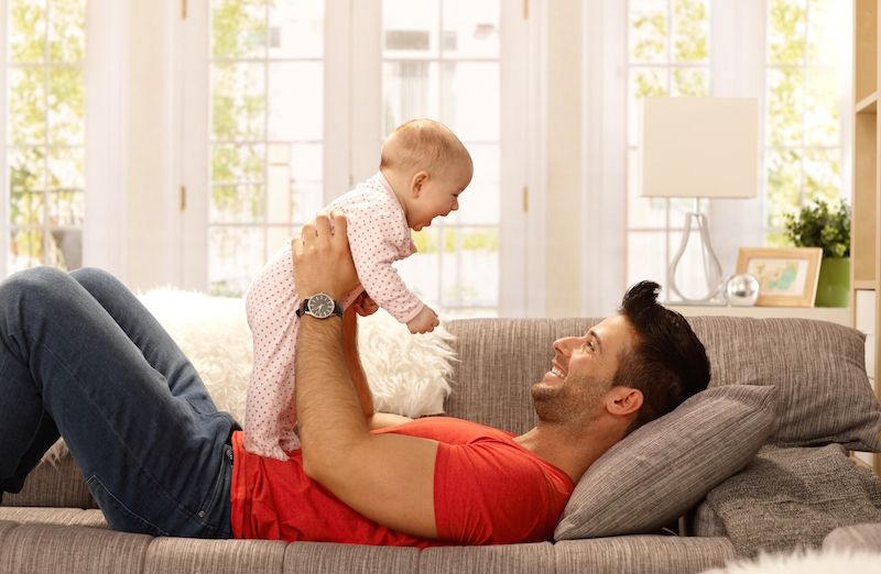 A dad plays with his baby.