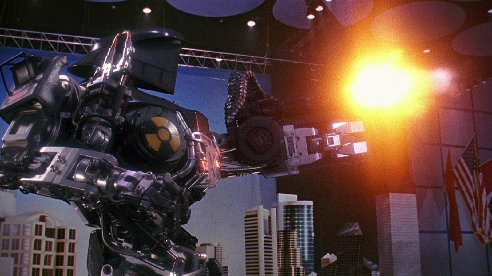 Still from the movie RoboCop 2 (1990).  A giant robot is firing a big gun.