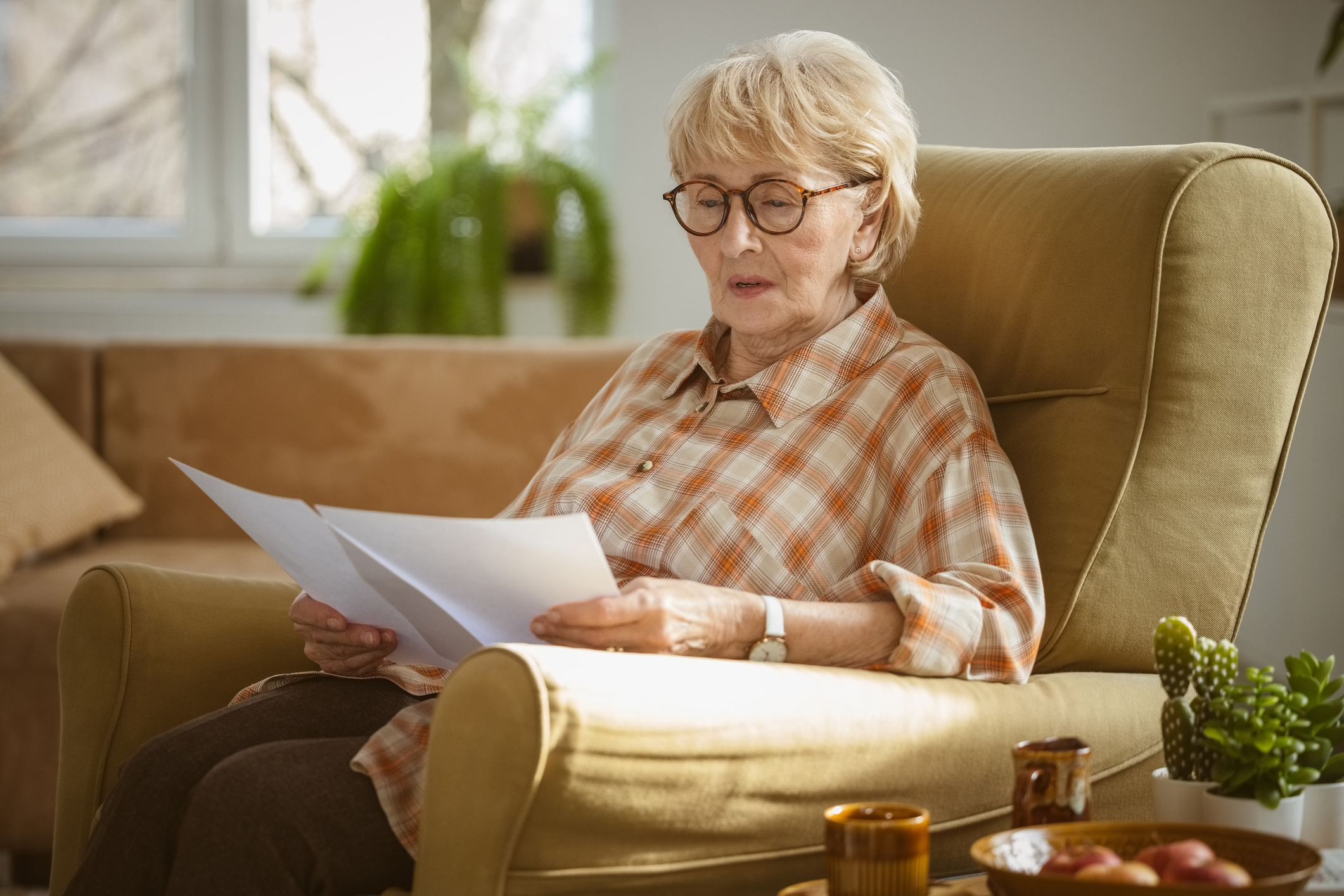 Worried state pensioner reading documents