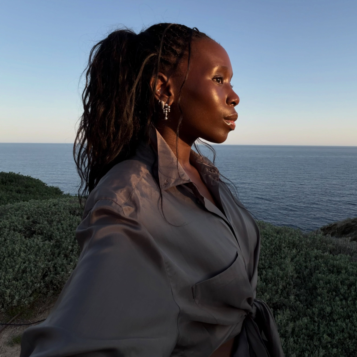 A woman by the beach during sunset