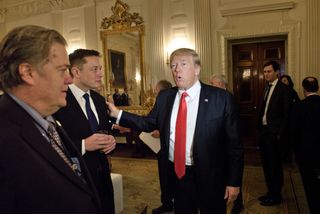 US President Donald Trump greets Elon Musk, SpaceX and Tesla CEO, before a policy and strategy forum with executives in the State Dining Room of the White House February 3, 2017 in Washington, DC