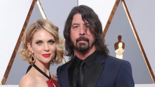 Dave Grohl and his wife posing at the 2016 Academy Awards