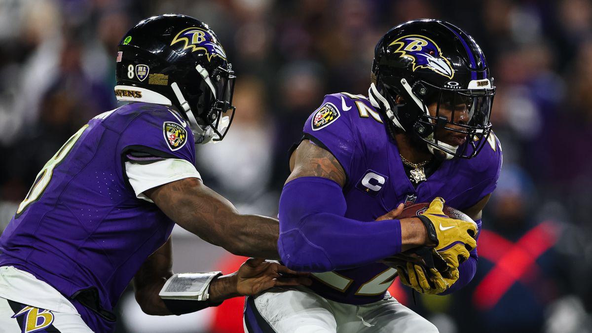 Derrick Henry #22 of the Baltimore Ravens takes a handoff from Lamar Jackson #8 during the first half of the AFC Wild Card Playoff game against the Pittsburgh Steelers 