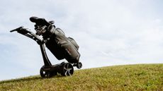 Stewart Vertx Remote going up a steep grassy hill