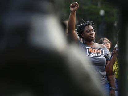 Ericka Robbins, of Birmingham, Ala., holds up her fist during a solidarity rally in Birmingham for the victims in Charlottesville.