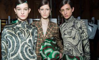 Models wear printed blouses with tailored suit, all in green/ brown tones and matching make-up.